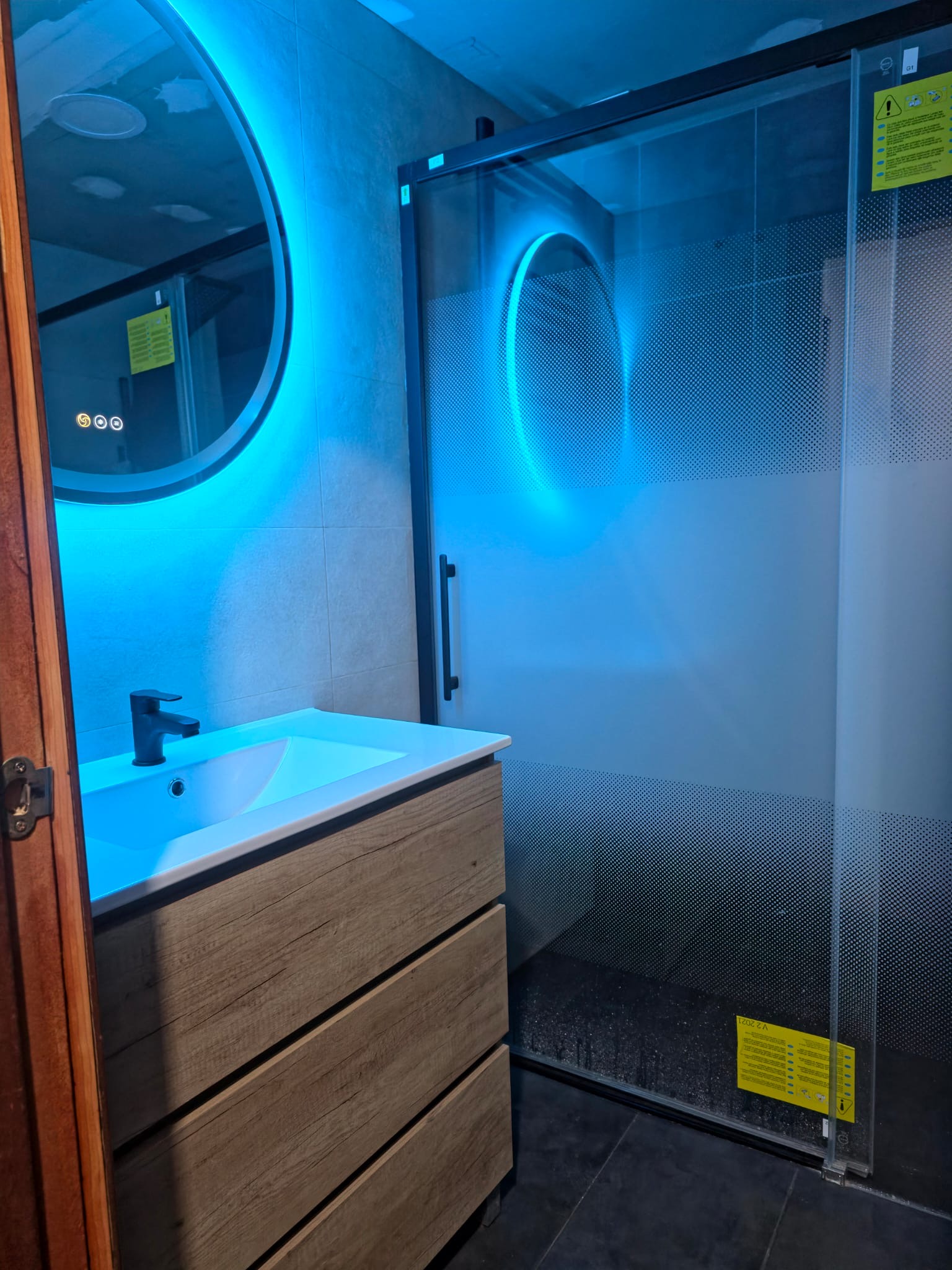 Baño con lavabo de madera y espejo LED - HG Reformas